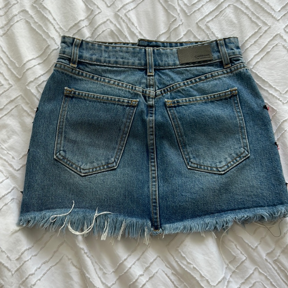jean skirt with red stars with black and white outline, fringy on the bottom - Picture 2 of 6